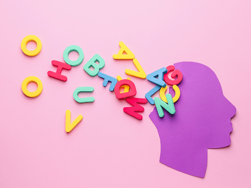 A purple paper head with a jumble of colorful letters spilling out from it