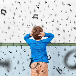 A child clutching both sides of his head surrounded by a jumble of letters