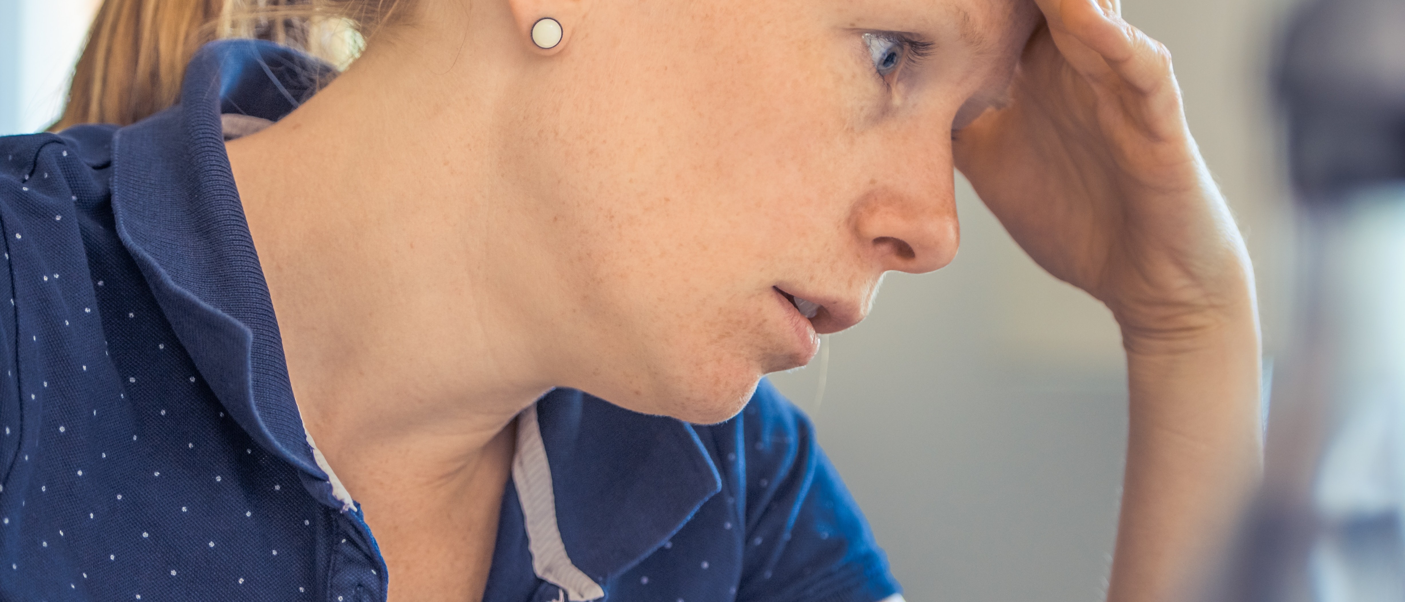 Stressed woman with hand on her head