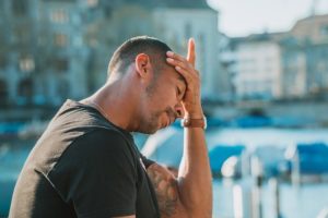A man attempts to ease his headache