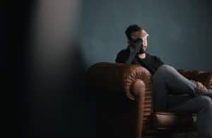 A man feels the stress of a headache