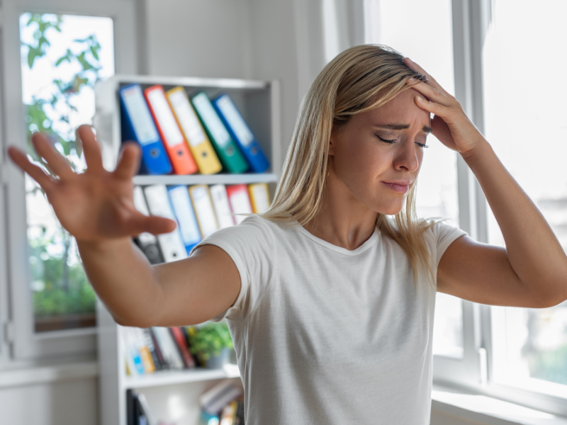 A woman suffering from headache, a common symptom of concussion