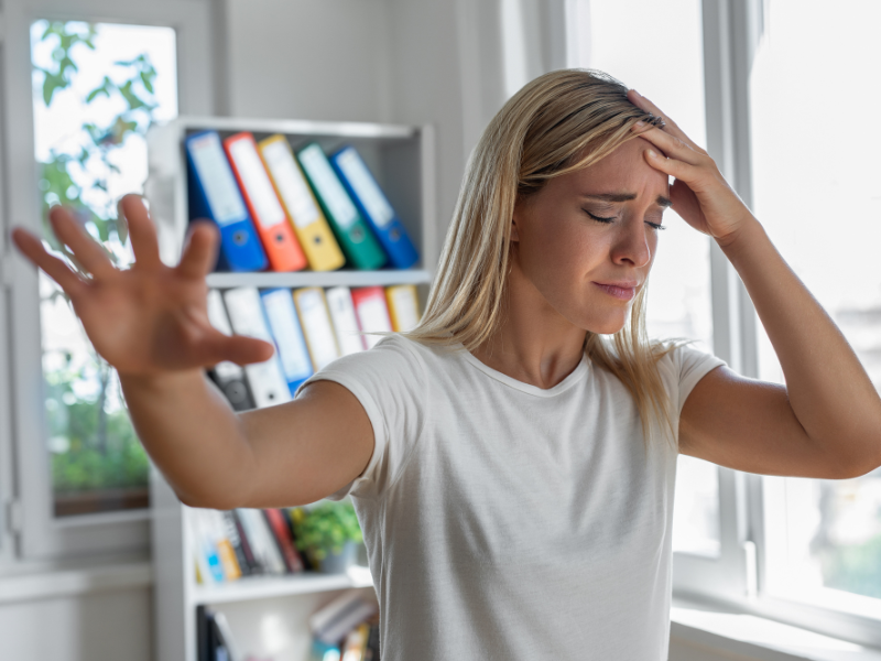 Una mujer con dolor de cabeza, síntoma habitual de conmoción cerebral.